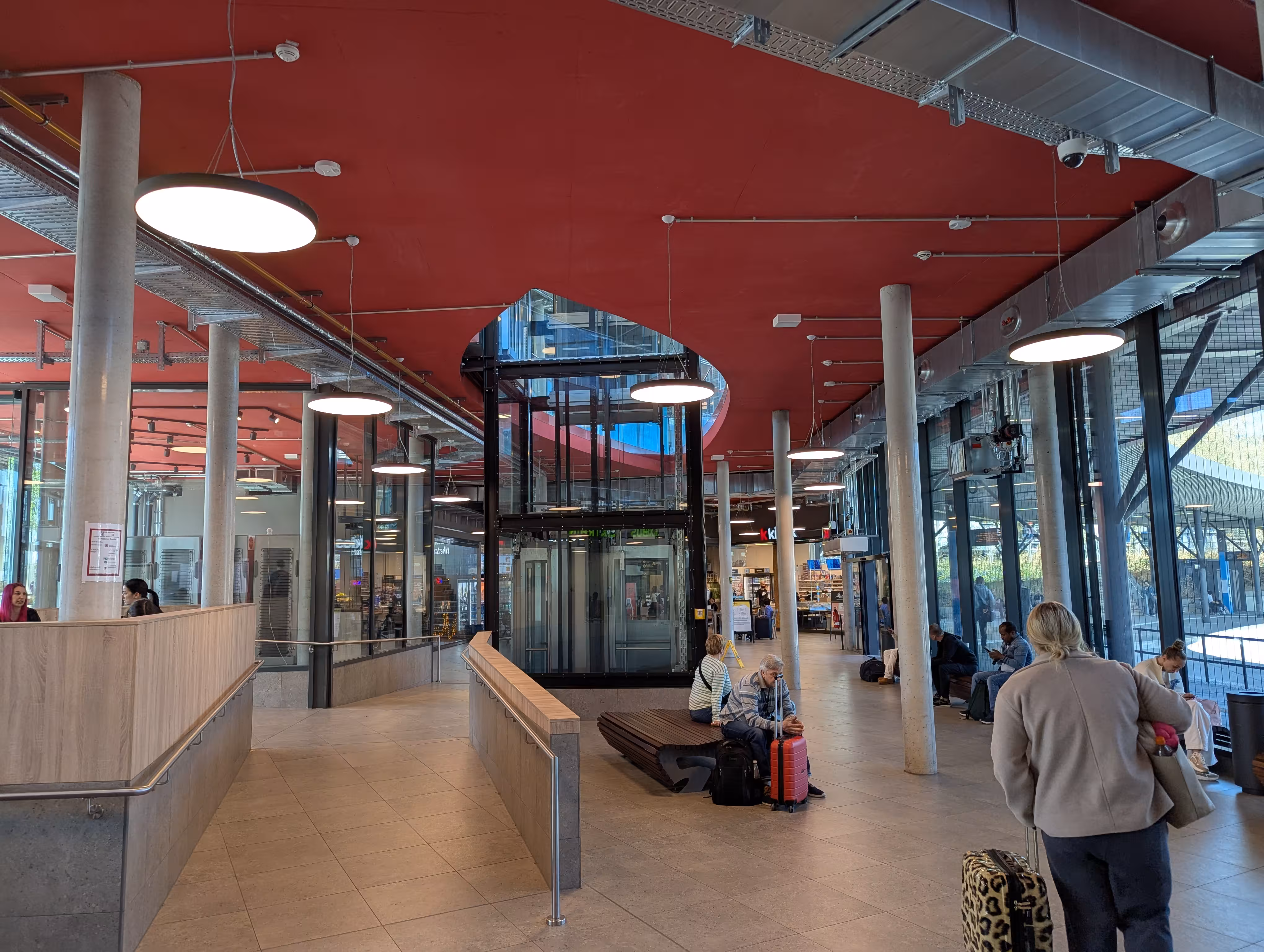 an interior view of the waiting hall with an elevator and a wheelchair ramp.